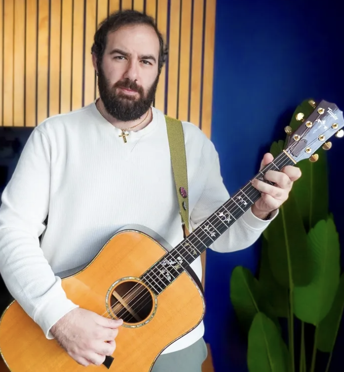 Nick Georghiou playing a Fender guitar